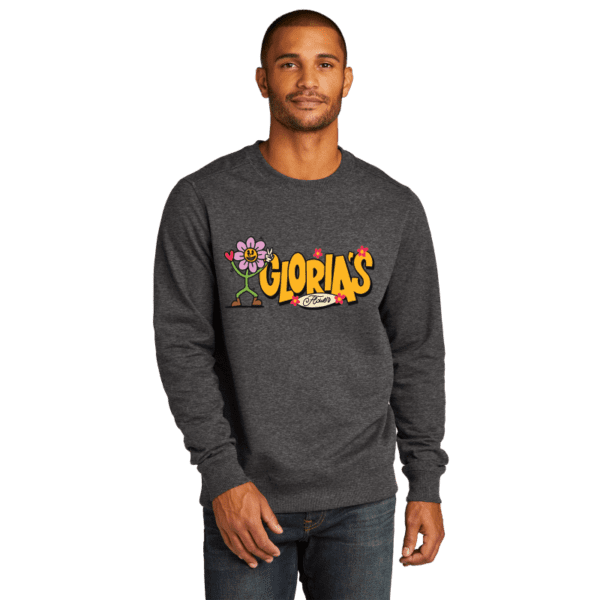 Man wearing grey crew neck sweater that says "Gloria's Flower" on front in a graffiti style font.