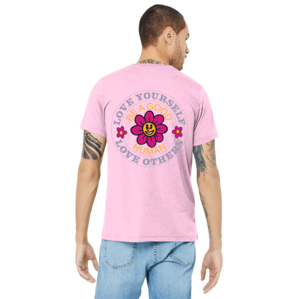 A man wearing a pink shirt with a flower on it.