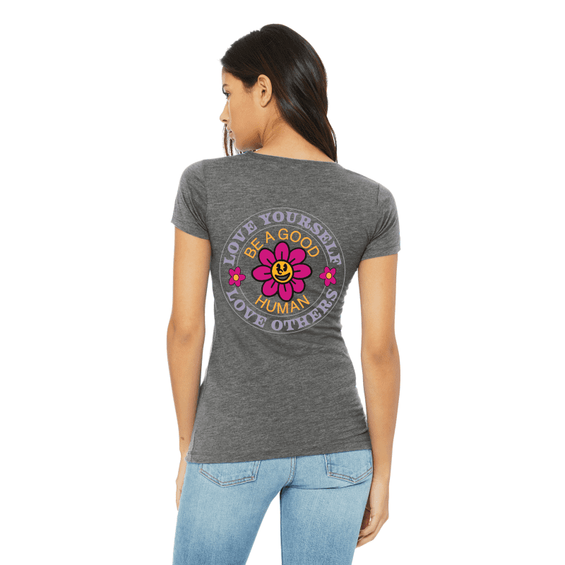 A woman wearing jeans and a t-shirt with a flower on it.