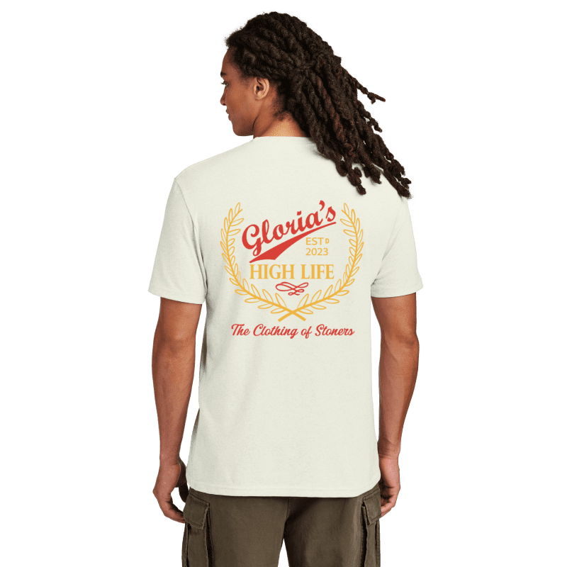 Man with braids wearing tee with graphic design on back.